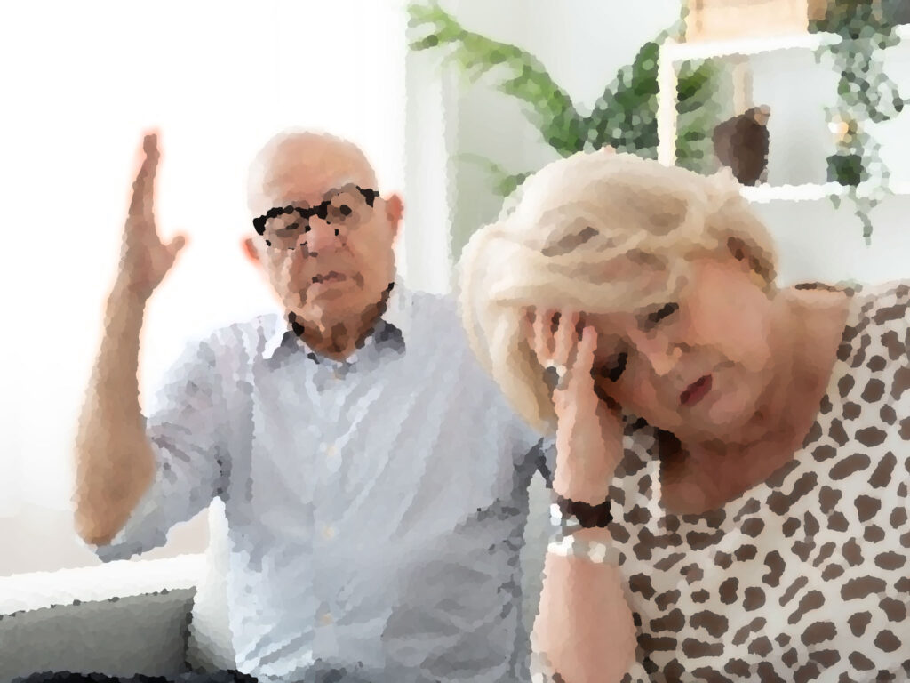 Tense elderly woman arguing with elderly man